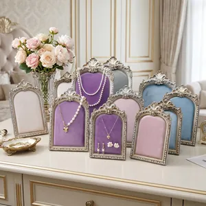 Macro view of vintage velvet jewelry stands in multiple colors and ornate silver frames