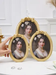 Detailed macro view of vintage gold oval resin photo frames featuring intricate rose carvings