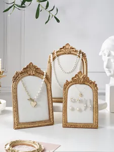 Vintage resin photo frame jewelry display stand, elegant gold carved necklace holder rack.