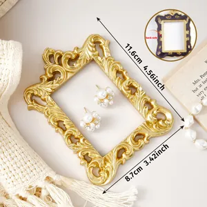 Close-up of ornate gold magnetic photo frame showing dimensions 11.6cm x 8.7cm