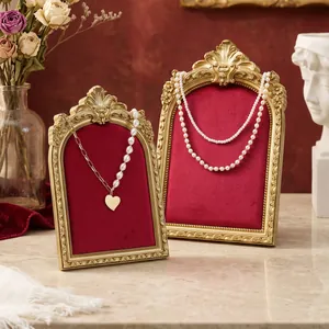 Vintage gold carved jewelry display frames with red velvet backing for necklaces