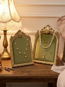 Vintage resin photo frame jewelry display stand, retro green velvet necklace holder for decor.
