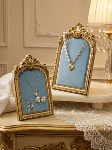 Vintage resin photo frame jewelry display stand with blue velvet for necklaces and earrings.