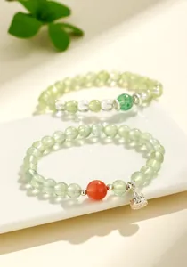 Detail shot of prehnite beaded bracelet with southern red agate and silver lotus pod charm