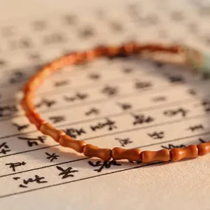 Elegant bamboo-joint shaped olive nut bracelet with natural Shoushan stone accent