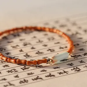 Zen style olive pit bamboo-shaped bracelet with elegant Shoushan stone bead detail
