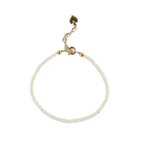Elegant minimalist fine white stone bead bracelet with gold clasp and heart charm