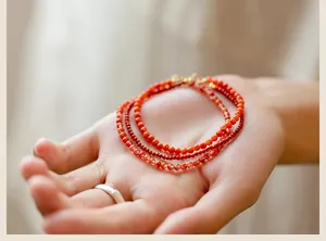 Close-up of 3mm natural Southern Red Agate beads on a delicate and thin bracelet