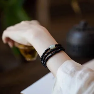 Pulsera de cuentas de ébano para mujer con detalle de jade Hetian de tres capas