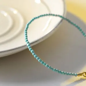 Minimalist handcrafted 2mm natural turquoise bead bracelet with elegant 14k gold accents