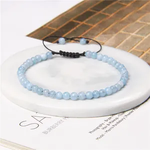 Detail view of 4mm light blue stone bead bracelet with adjustable black braided cord