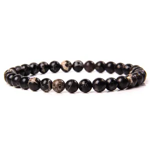 Detailed macro view of 6mm polished natural map stone beaded elastic bracelet for women