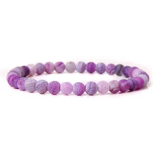 Macro view showing the detailed texture of purple 6mm cracked natural stone beads on a bracelet.