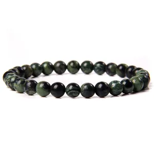 Close-up of 6mm polished natural stone beaded bracelet featuring unique marbled textures