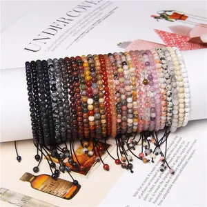 Close-up of 4mm natural stone bead bracelets with adjustable braided strings in multiple colors