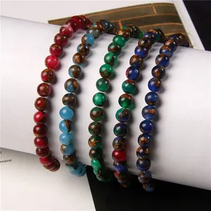Detail view of 6mm natural stone elastic beaded bracelets in five various colors