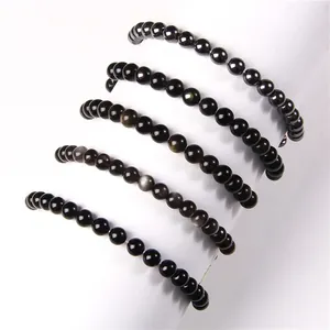 Detail view of 6mm polished natural stone bead elastic bracelets in various dark tones.