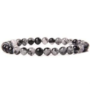 Fashionable elastic bracelet crafted with 6mm smooth natural black rutilated quartz beads.