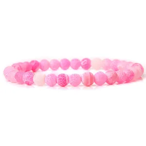 Elegant pink 6mm natural stone beaded stretch bracelet featuring unique frosted cracked texture