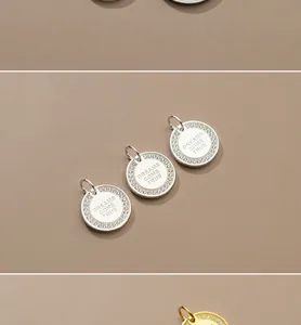 Detail of silver round pendants engraved with Dreams Come True and micro-pave stones