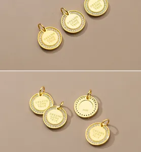 Detail of S925 silver gold-plated pendant with Dreams Come True engraving and crystals