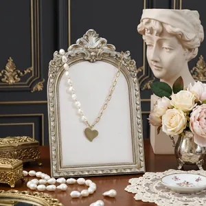 Vintage European-style picture frame jewelry display stand with heart necklace detail