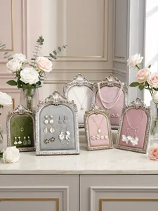 Resin photo frame jewelry display stand, vintage carved design for necklace and earrings storage.