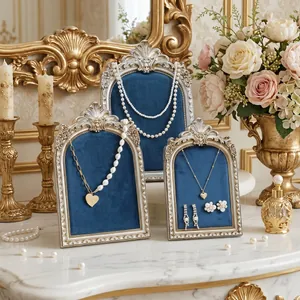 Retro European style jewelry display stands with ornate silver frames and blue velvet