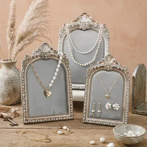 Vintage resin photo frame jewelry display stand for necklaces earrings ring retail showcase.