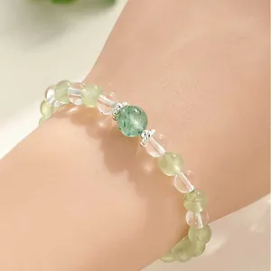 Elegant natural prehnite and clear quartz beaded bracelet for women shown on a wrist