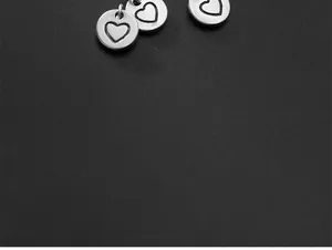 Detail shot of S925 silver vintage heart disc charm for DIY jewelry making and bracelet design.