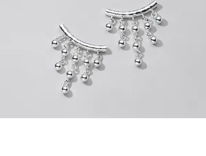 Macro view of S925 sterling silver curved tube pendant with 6mm ball tassels.