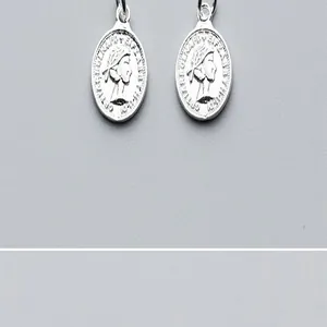 Detailed macro view of vintage S925 silver coin pendants featuring queen profile