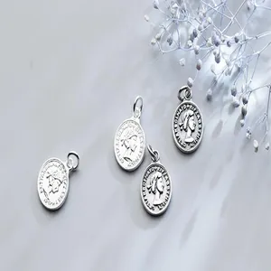 Macro view of vintage S925 sterling silver Queen Elizabeth coin pendants for DIY jewelry