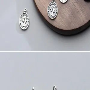 Detailed view of a vintage S925 silver Queen Elizabeth coin pendant charm