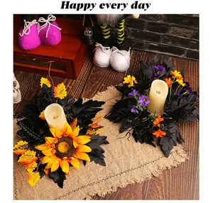 Corona para vela de Halloween con girasoles y hojas negras en una mesa decorada