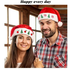 Adult embroidered red velvet Christmas Santa hats shown on a happy smiling couple