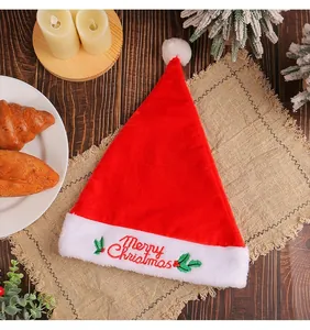 Close-up detail of a thickened red velvet Christmas hat with Merry Christmas embroidery