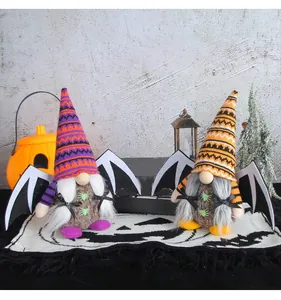 Set of two Halloween gnomes with bat wings and knit hats on a festive ghost mat