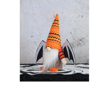 Detail of Halloween gnome plush doll with bat wings and orange striped knitted hat