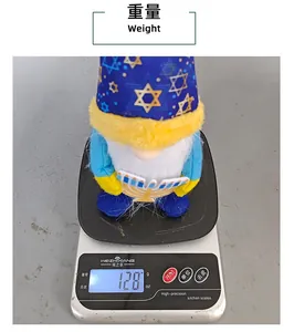 Macro view of a Hanukkah gnome figurine being weighed on a digital scale showing 128 grams