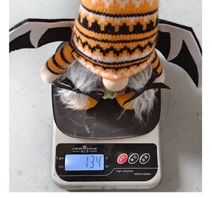 Close-up of a Halloween bat gnome on a digital scale showing weight of 134 grams.