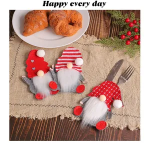 Set of three festive Christmas gnome cutlery holder sleeves for holiday dining table decoration