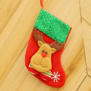 Detailed view of a red sequined Christmas stocking with a cute reindeer applique