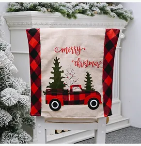 Detail showing festive Christmas chair cover with red plaid truck on a white chair.