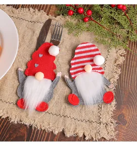 Detailed view of Christmas gnome felt cutlery holders on a festive table setting