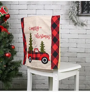 Detail view of burlap Christmas chair cover with red plaid truck and Merry Christmas text.