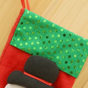 Detailed macro view showing the shiny green sequined cuff of a red felt Christmas stocking