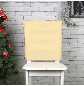 Backrest detail of a cream-colored Christmas chair cover with faint festive text patterns