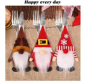 Close-up of festive gnome Christmas cutlery holders on a rustic burlap tablecloth